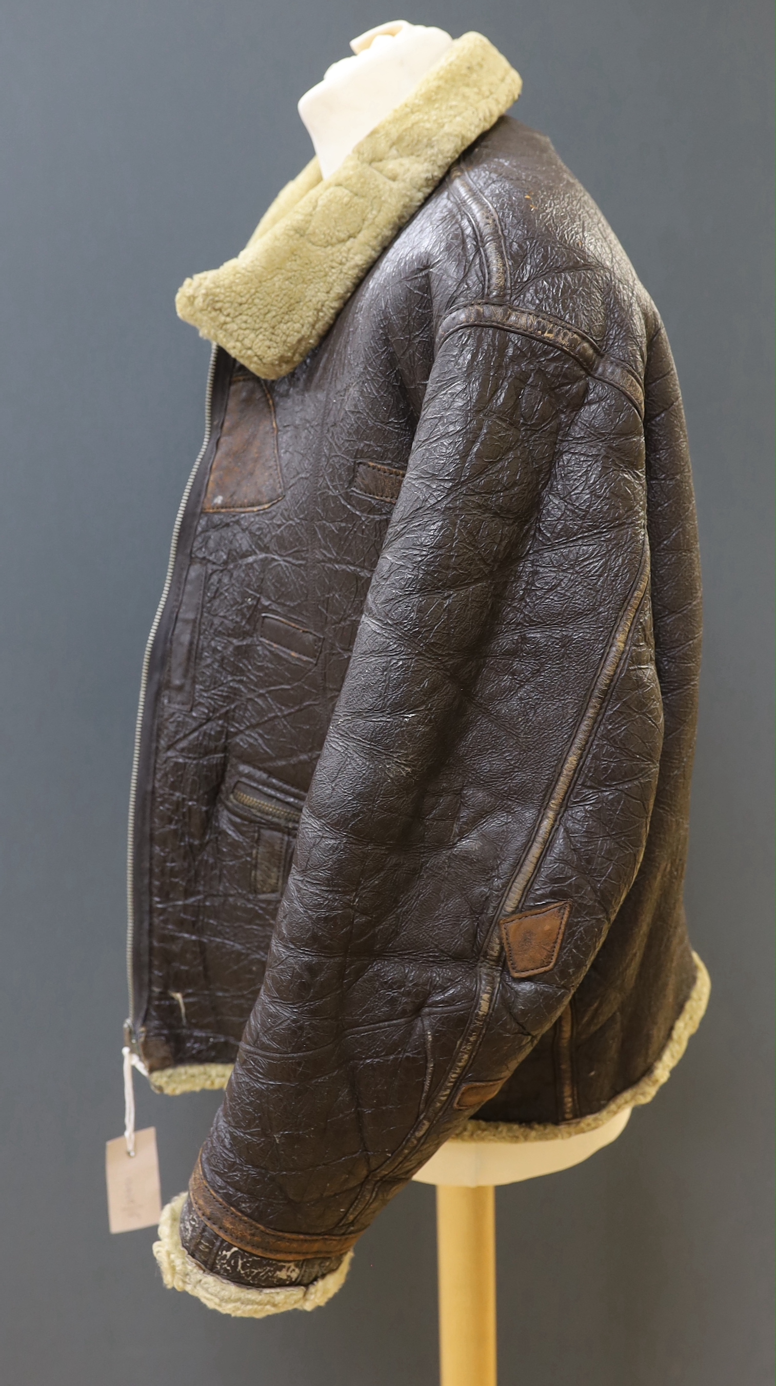 An American US Air Force sheepskin flying jacket, with applied label in collar reading ‘TYPE ….. SIZE MEDIUM SPEC NO. 94-3084 ORDER NO 42-12685-P PROPERTY AIR FORCE U.S. ARMY H. BERNSTEIN & CO.’